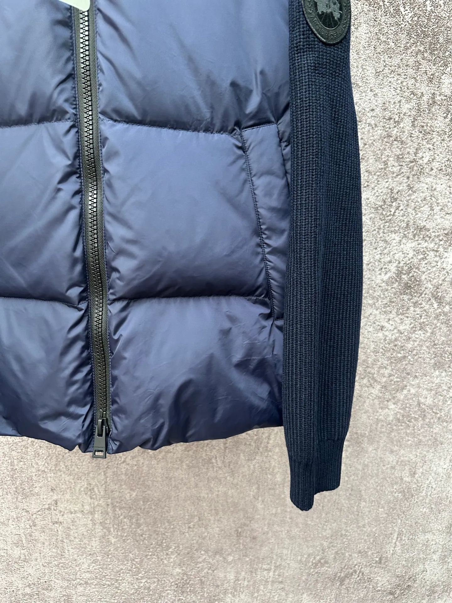 P930 Canada Goose Armband Hooded Down Jacket Fabric selection: The use of high-quality protective nylon fabric not only enhances the wear resistance of the surface, but also takes into account wind resistance, ensuring excellent performance in various harsh weather conditions.  90 national standard high-quality white duck down: selected high-loft down, weighing 170g, light and warm, with excellent temperature locking performance and good resilience.  Three-dimensional quilting process: Precision thread reinforcement to prevent velvet drilling and ensure that the fluffy and resilient elasticity lasts as new.  7-needle medium-thick knitted structure: Use thicker yarns to knit woolen fabrics with obvious thickness and weight. The texture is clearly visible and has a rough, retro texture. It has a good skeleton feel, is relatively stiff, and can maintain the silhouette of clothing for a long time. It also provides more layers of still air to lock in heat.  There is a brand exclusive LOGO on the woolen sleeve arms. It is dark and not obvious in the photo.  Accessories: One-to-one customized logo, one-to-one customized zipper pendant, one-to-one customized snap button SIZE: S M L XL